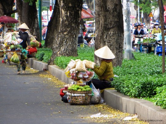 Sidewalk vendor in cone hat